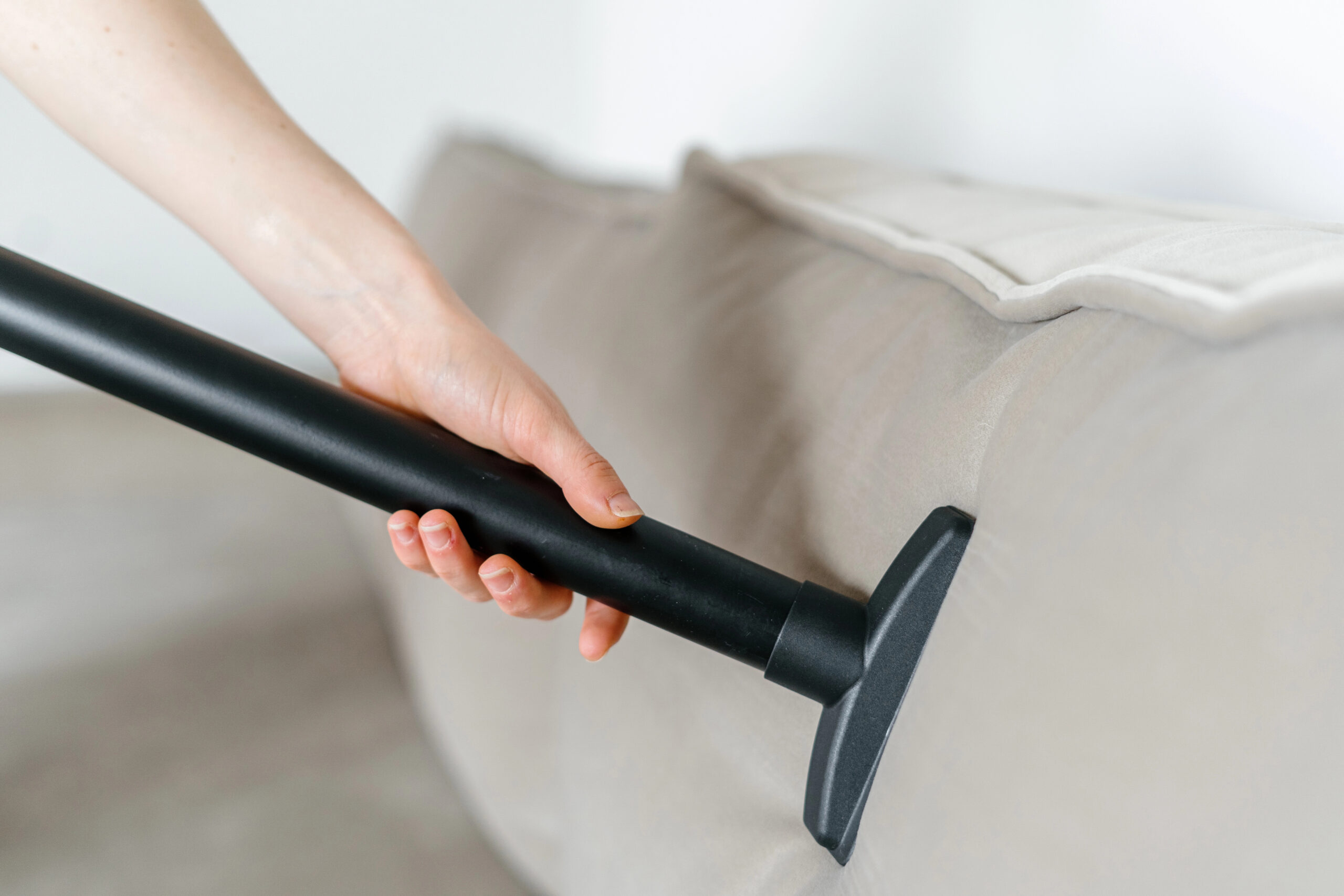 woman holding a vaccuum cleaner to kill bed bugs