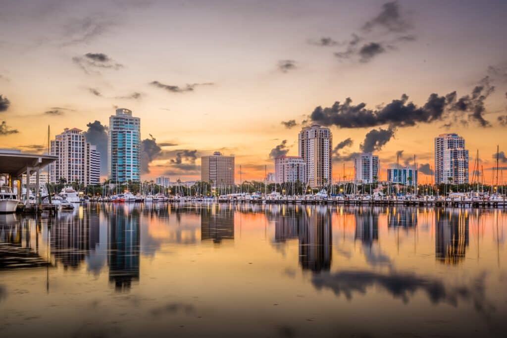 Scenic view of downtown St. Petersburg, FL at sunset with boats docked along the marina, highlighting the coastal city's need for effective termite treatment due to its warm, humid climate.